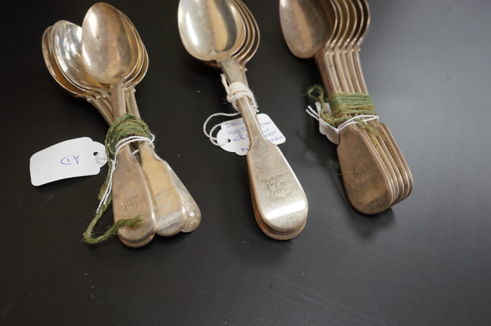 A set of ten George IV silver fiddle pattern table spoons and five dessert spoons by William M. Traies, London, 1829 and one other matched silver dessert spoon, 32.7oz.